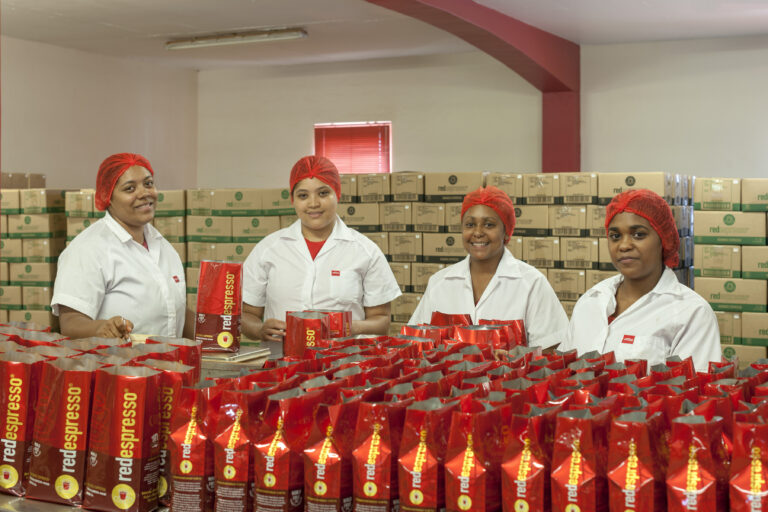 The red production team hand packing 1kg bags of Red Espresso in the Red Espresso factory.